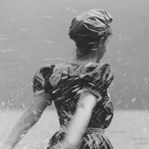 Home Woman on beach, splashing water.